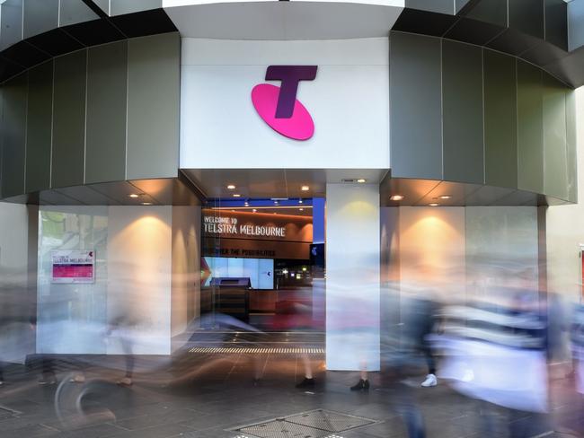 Pedestrians walk past a Telstra Corp. Discovery store in Melbourne, Australia, on Tuesday, Feb. 9, 2016. Telstra, Australia's biggest phone company, is scheduled to report half-year results on Feb. 18. Photographer: Carla Gottgens/Bloomberg