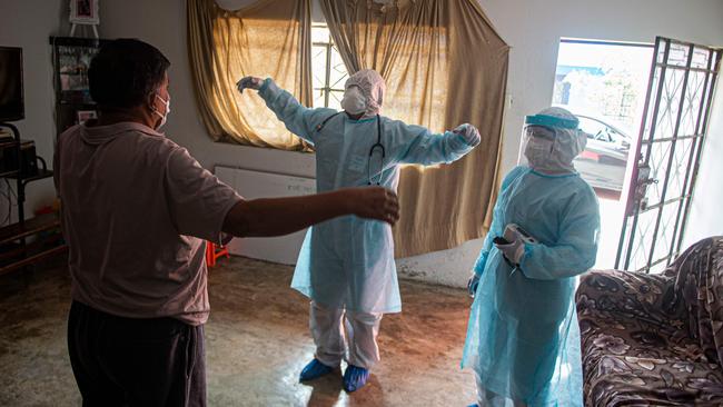 Doctors visit a patient with COVID-19 in Comas, on the northern outskirts of Lima, Peru. Picture: AFP