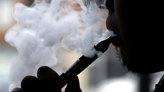 A man smokes an electronic cigarette. Photo: AP