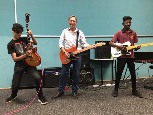 Blacktown Boys High principal Shaun Addy with Zach Flores and Benji Joseph rock out for the school men’s health day. Picture: Heath Parkes-Upton