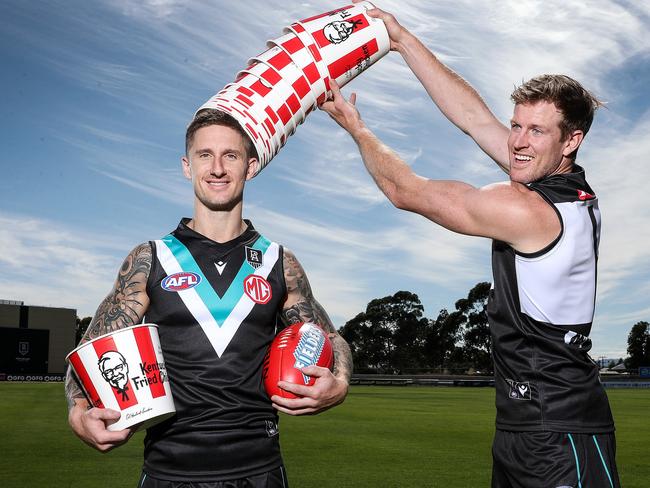 AFL - Thursday, 10th December, 2020 - Port Adelaide's Hamish Hartlett and captain Tom Jonas with KFC buckets to promote their new sponsor which will appear on their playing shorts and top. Picture: Sarah Reed