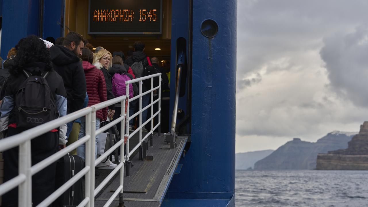 Passengers board a ferry bound for the Greek mainland. Picture: AP Photo/Petros Giannakouris