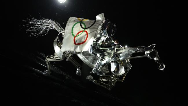 The Horsewoman, wearing the Flag of the International Olympic Committee (IOC), is seen on a Metal Horse the River Seine during the opening ceremony. Photo by Lars Baron/Getty Images.