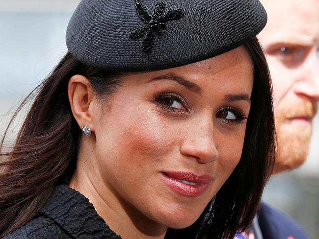 (FILES) In this file photo taken on April 25, 2018 Britain's Prince Harry (R) and his US fiancee Meghan Markle arrive to attend a service of commemoration and thanksgiving to mark Anzac Day in Westminster Abbey in London. Glamorous and elegant, Meghan Markle is set to freshen up the British royal family dress code, all while tailoring her outfits to suit her new role. Markle is "a hint of Grace Kelly, a dose of Alicia Keys, a touch of Amal Clooney and a lot of Kate Middleton," said French magazine Madame Figaro. / AFP PHOTO / Adrian DENNIS