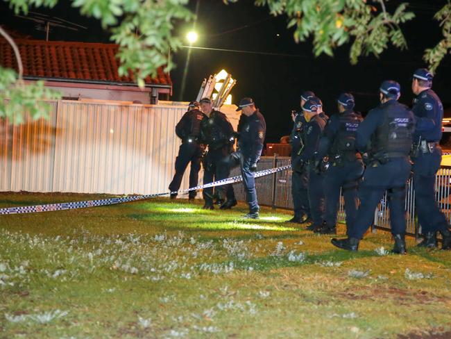 Police search a park on the street. Picture: Damian Hofman