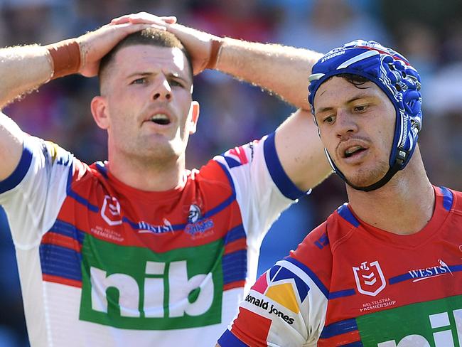 Lachlan Fitzgibbon (left) and Kayln Ponga of the Knights react following a Titans try during the Round 6 NRL match between the Gold Coast Titans and the Newcastle Knights at CBUS Stadium on the Gold Coast, Sunday, April 21, 2019.  (AAP Image/Dave Hunt) NO ARCHIVING, EDITORIAL USE ONLY