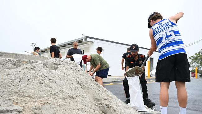 Members of Eastern Suburbs Soccer Club fill sandbags at Heath Park. Picture: Getty Images