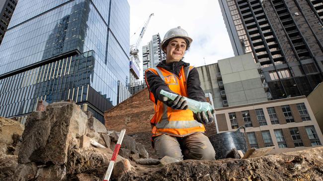 Archaeologist Marianne Odisho working at the site with Melbourne’s towering skyscrapers in the background. Picture: Jason Edwards