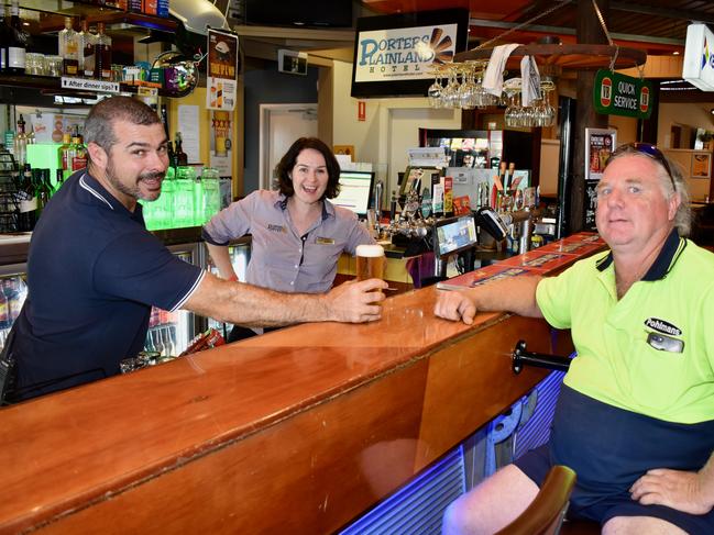 Chris Donovan (right) enjoys a cold beer on the house after he helped save Mel and Michael's Porters pub early in the morning. Photo: Hugh Suffell.