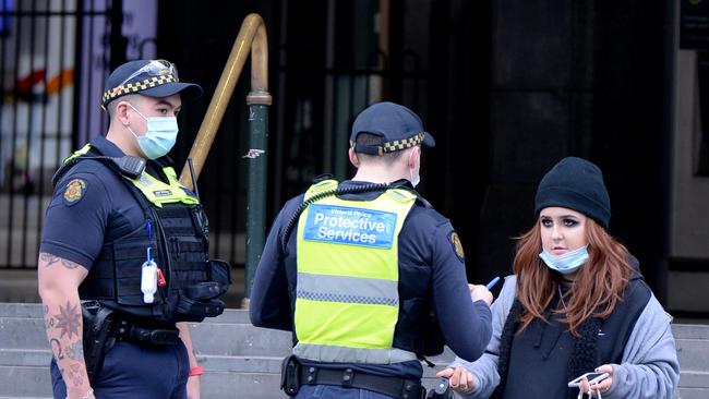 Police conduct random ID checks outside Flinders Street Station in Melbourne on Tuesday. Picture: Andrew Henshaw