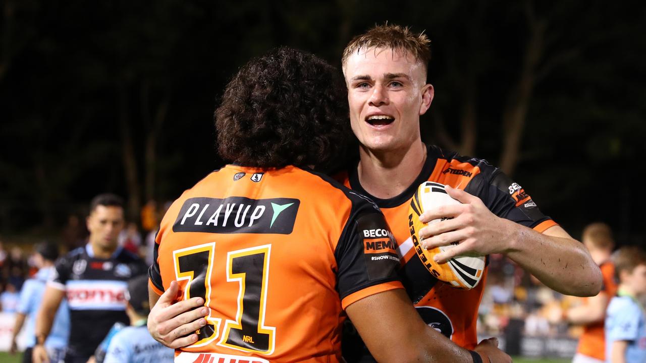 Lachlan Galvin of the Tigers embraces with his teammate after winning the round three NRL match between Wests Tigers and Cronulla Sharks at Leichhardt Oval, on March 23, 2024, in Sydney, Australia. (Photo by Jeremy Ng/Getty Images)