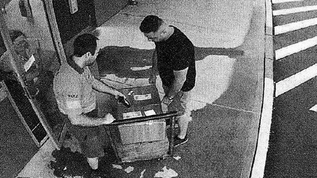 Halil Delialioglu (dark shirt) picking up boxes of GBL from a Toll shipping depot in Eastern Creek. Picture: NSW Police