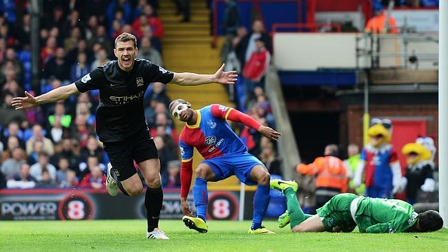 Edin Dzeko celebrates scoring the opening goal for Manchester City.