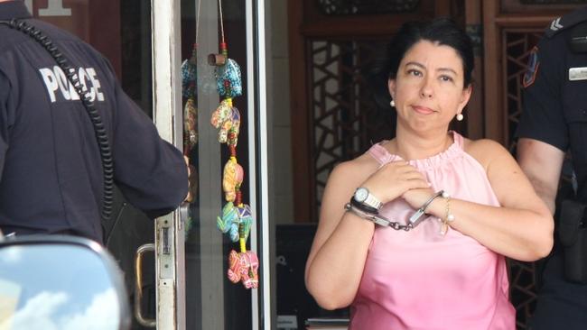 Xana Kamitsis being arrested at the premises of Altitude Travel, which she owns. Picture: NT News