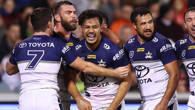 Jeremiah Nanai celebrates with teammates after scoring a crucial try for the Cowboys. Picture: Mark Nolan/Getty Images