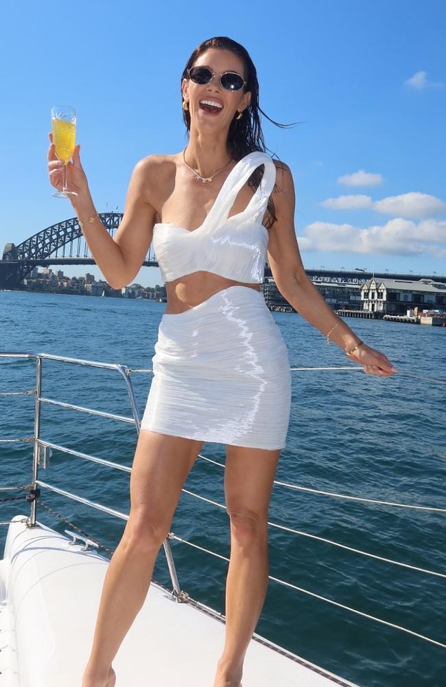 The Life Uncut host wore a white mini-skirt and a structured one-shoulder crop top for her pre-wedding bash. Picture: Instagram/BrittanyHockley