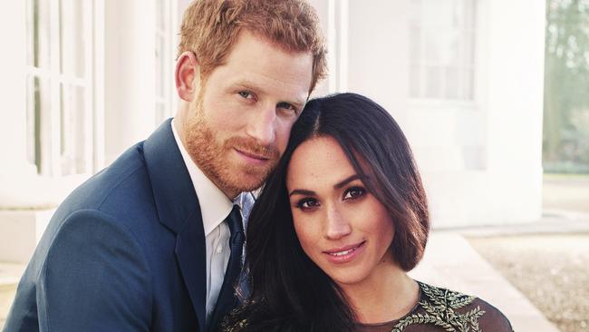 In this photo released by Kensington Palace on Thursday, Dec. 21, 2017, Britain's Prince Harry and Meghan Markle pose for one of two official engagement photos, at Frogmore House, in Windsor, England. (Alexi Lubomirski via AP)