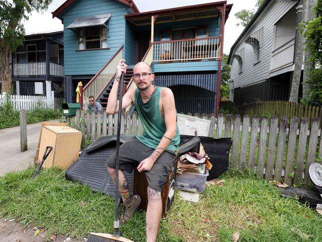 Martin Wright (front) and Will Orrick, with the ruined furniture some from two weeks ago and from yesterday, cleaning up there house at 85 Longlands St Gabba, Flooding Clean Up, Gabba - on Sunday 15th December 2024 - Photo Steve Pohlner