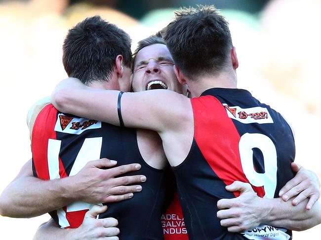 SANFL - Grand Final - Woodville-West Torrens Eagles v West Adelaide at Adelaide Oval. Shannon Green (centre) screams as the Bloods get the win - being hugged by Jonathon Beech and Aaron Fielke. Photo Sarah Reed.