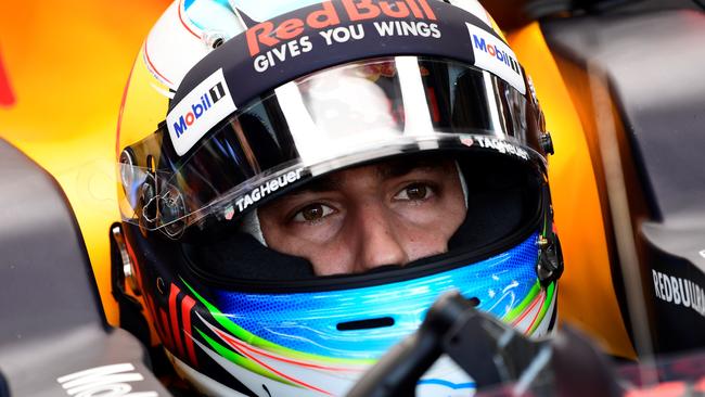 Red Bull's Australian driver Daniel Ricciardo sits in his car in the pits.