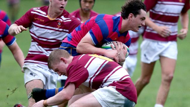 The outstanding tackling technique of John Radel from St Peter Lutheran College. (Image AAP/Steve Pohlner)