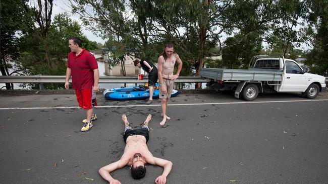 An exhausted resident of Rocklea after retrieving his family photos and other prized possessions in Brisbane on Wednesday, Jan. 12, 2011.