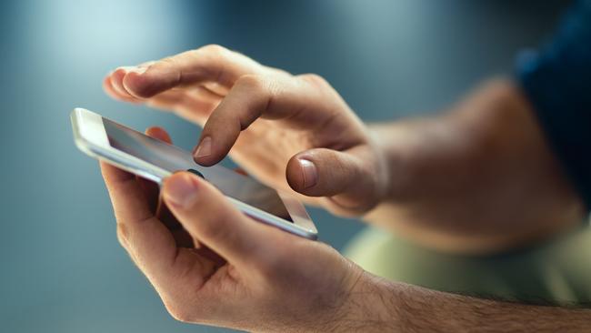 Generic Male hands typing on smartphone. Picture: Istock