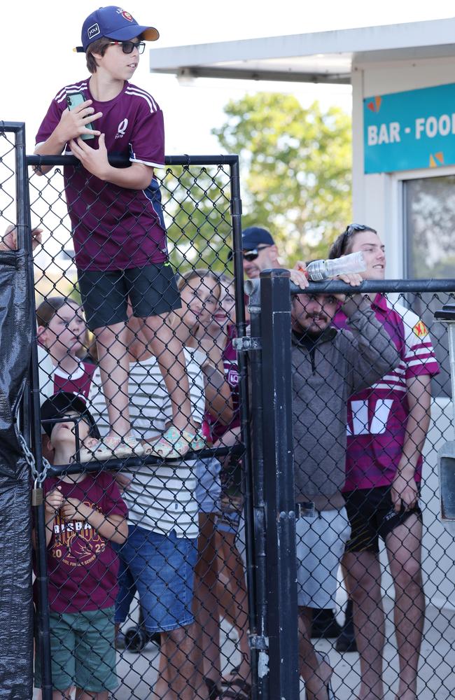Queensland fans try to get a glimpse of players arriving at the Maroons open training day. Picture Lachie Millard