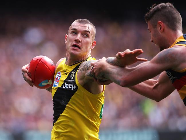 Richmond's Dustin Martin fends off Adelaide's Rory Atkins. Picture. Phil Hillyard