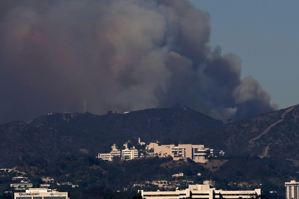 Los Angeles investigates fire blame as curfew enforced