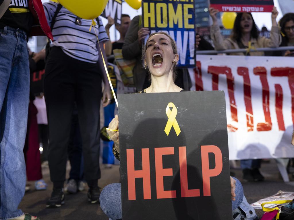 A woman holds a sign during a demonstration calling for a hostage deal in Tel Aviv.