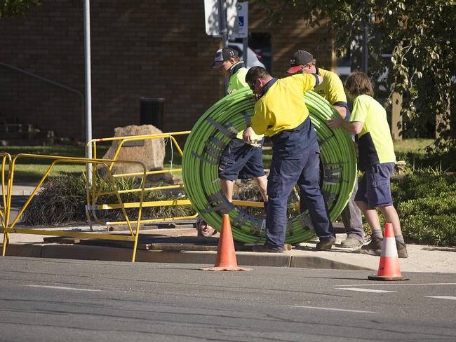 NBN workers roll out cabling.