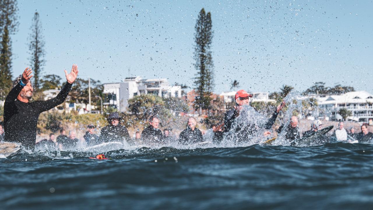 Hundreds gathered to farewell Bill Carey during a paddle out at The Bluff at Alexandra Headland. Picture: Moment of Stoke