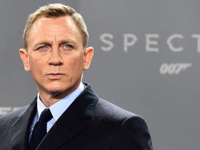 (FILES) In this file photo taken on October 28, 2015 British actor Daniel Craig poses for photographers at a photocall for the new James Bond film 'Spectre' in Berlin. - New James Bond footage from historic Hollywood studio MGM shook and stirred the movie theater industry's CinemaCon summit in Las Vegas August 24, 2021, as executives struck a defiant note about the future of the big screen. (Photo by TOBIAS SCHWARZ / AFP)