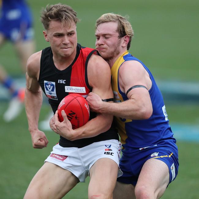 Benalla recruit Nick Mellington, right, playing for Williamstown in the VFL and tackling Essendon’s Dylan Clarke. Pic: Michael Klein.