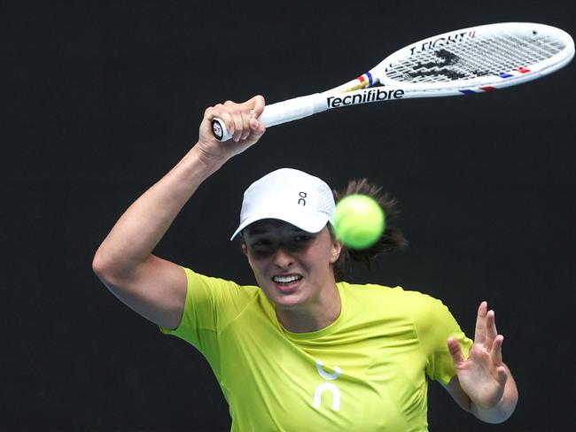 Poland's Iga Swiatek hits a return during a training session ahead of the Australian Open tennis tournament in Melbourne on January 9, 2025. (Photo by DAVID GRAY / AFP) / -- IMAGE RESTRICTED TO EDITORIAL USE - STRICTLY NO COMMERCIAL USE --