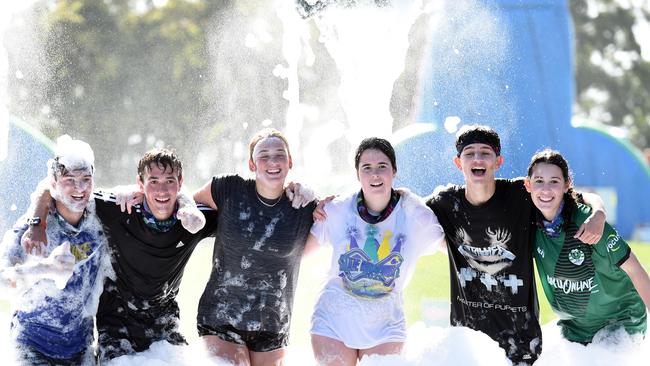 Competitors celebrate after completing the Yarra Valley 5k Foam Fest in Wandin North on Saturday. Picture: David Smith