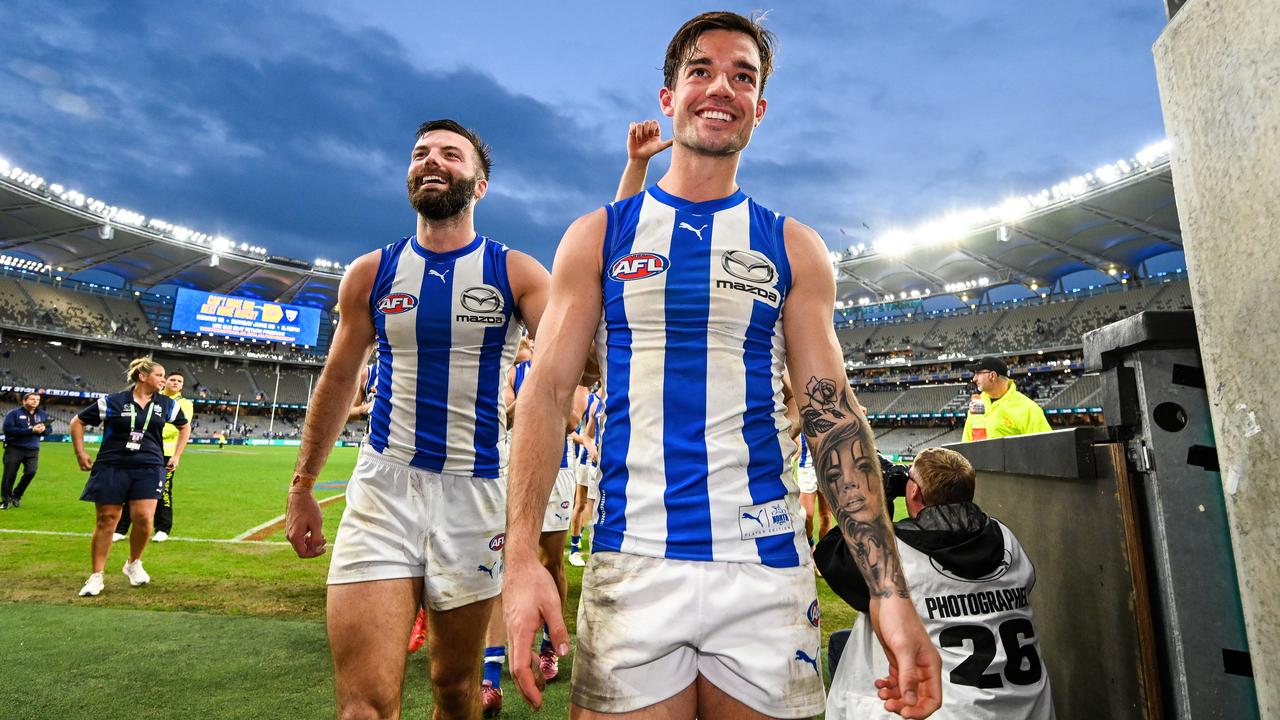 PERTH, AUSTRALIA - JUNE 08: Jy Simpkin of the Kangaroos leads his team to the rooms after the win during the 2024 AFL Round 12 match between the West Coast Eagles and the North Melbourne Kangaroos at Optus Stadium on June 08, 2024 in Perth, Australia. (Photo by Daniel Carson/AFL Photos via Getty Images)