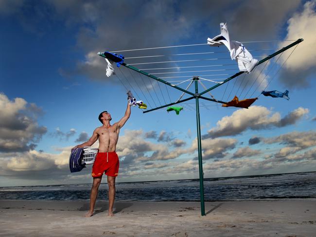 Iconic Antipodean installation by Andrew Baines. Henley SLSC members pictured at Henley Beach hanging their washing on Hills Hoist's. Pictured: Simon Mitris from Henley SLSC.