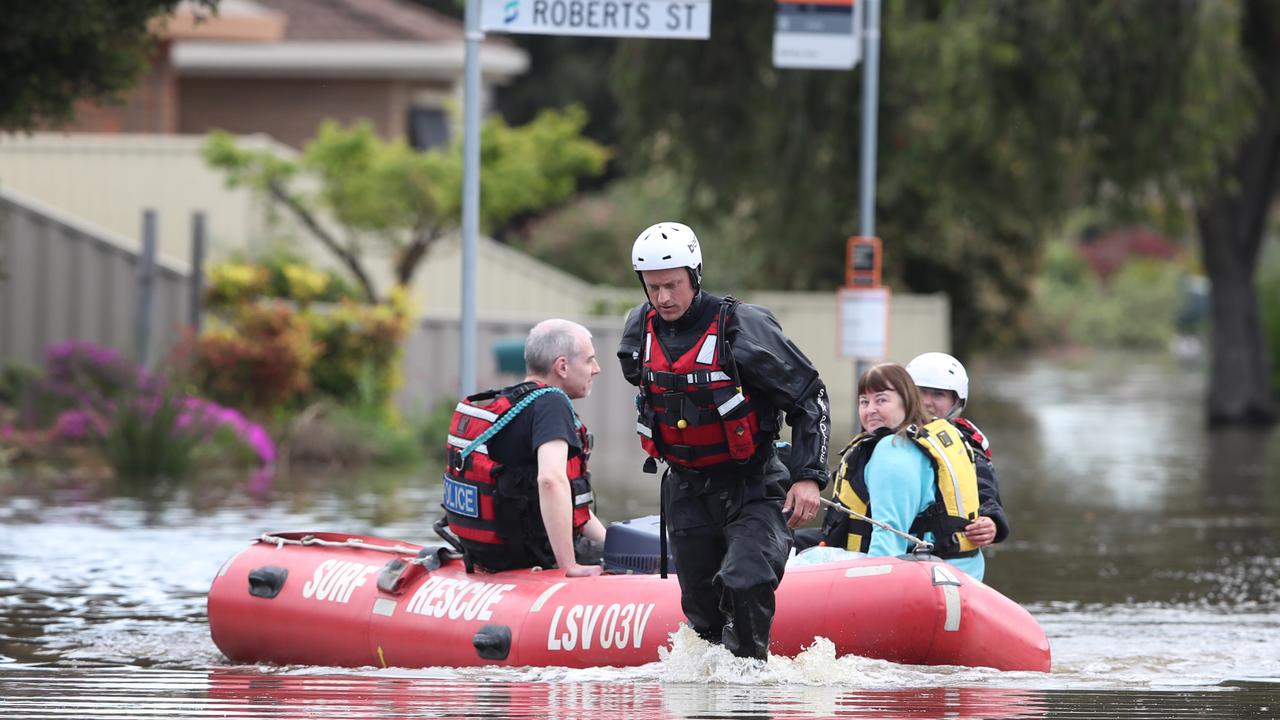 Water police rescue a woman from her home. Picture: David Crosling