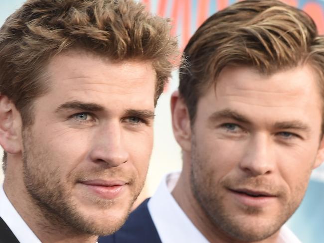 Actors Liam Hemsworth (L) and Chris Hemsworth arrive for the premiere of Warner Bros' 
