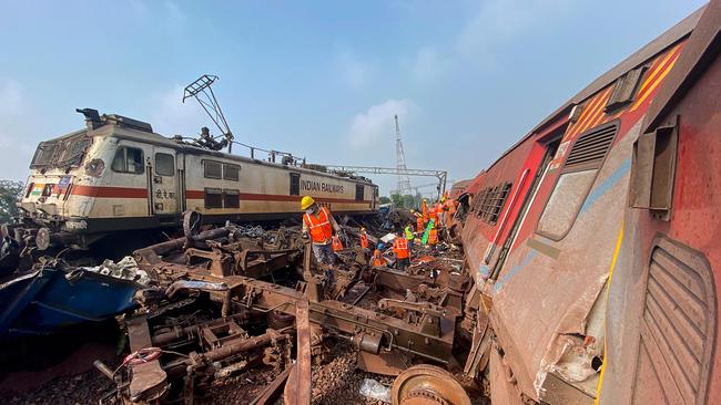 A rescue worker sifts through wreckage at the accident site of a three-train collision near Balasore. Picture: AFP