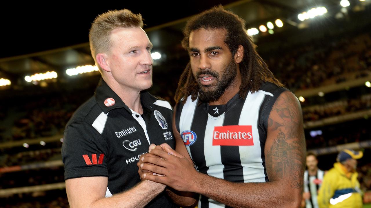 Collingwood coach Nathan Buckley celebrates a win with Heritier Lumumba in 2013.