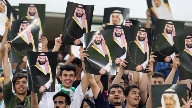 Saudi Arabia fans cheer as they hold up pictures of Saudi King Salman and Saudi Crown Prince Mohammed bin Salman during the 2018 World Cup group B qualifying soccer match between Saudi Arabia and Japan in Jeddah, Saudi Arabia on Tuesday 5 September 2017.