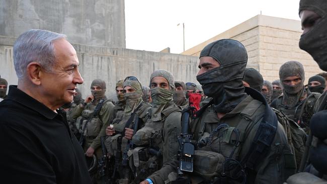 Israeli Prime Minister Benjamin Netanyahu poses for a photo with soldiers as he visits an Israeli army base in Tze'elim, Israel. Picture: Twitter/Benjamin Netanyahu