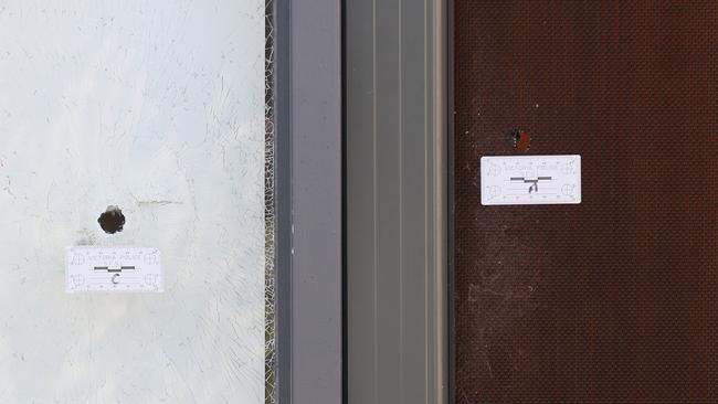 Three bullet holes in the front door of Mr Dank’s home. David Crosling