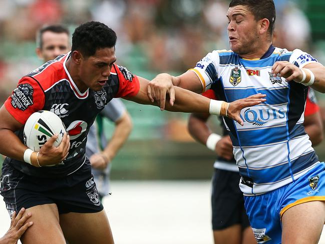 PALMERSTON NORTH, NEW ZEALAND - FEBRUARY 19: Roger Tuivasa-Sheck of the Warriors is tackled by Ryan James and Ash Taylor of the Titans during the NRL Trial match between the Warriors and the Gold Coast Titans at Central Energy Trust Arena on February 19, 2017 in Palmerston North, New Zealand. (Photo by Hagen Hopkins/Getty Images)