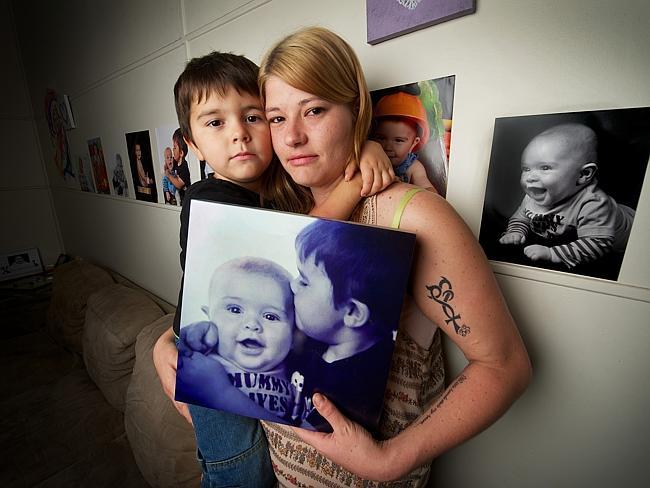 Casey Veal with elder son Xavier and a photo of Zayden.