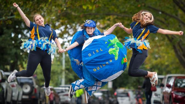 Maddy McKinnon (17, centre) from Monash District Girl Guides practices her Birdman Rally flying style, with help from fellow Girl Guides, Elana Katsaras (16) and Polly Sejavka (17). Picture: Jay Town