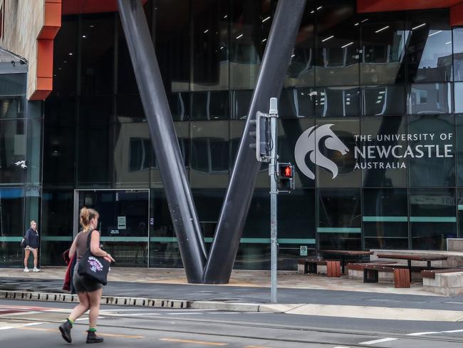 NEWCASTLE, AUSTRALIA - MAY 07: People walk next to the NUSpace building of the University of Newcastle on May 07, 2024 in Newcastle, Australia. Australia's Labor government is grappling with a slowing economy, weaker commodity prices, soaring housing costs and a softening labor market as it prepares to unveil its federal budget on May 14. To counter these headwinds, the budget is expected to feature smaller revenue upgrades compared to recent years, while outlining the government's interventionist policies aimed at boosting domestic manufacturing and the transition to green energy. Critics warn that such industrial policies risk fueling inflation and diverting resources from more productive sectors of the economy. (Photo by Roni Bintang/Getty Images)